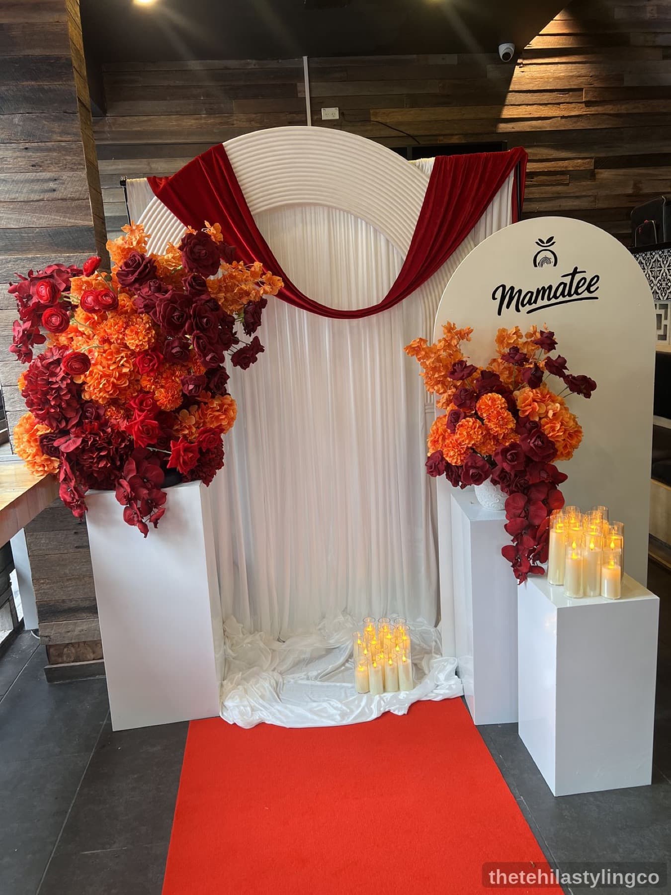 White ribbed arch with burgundy and orange florals